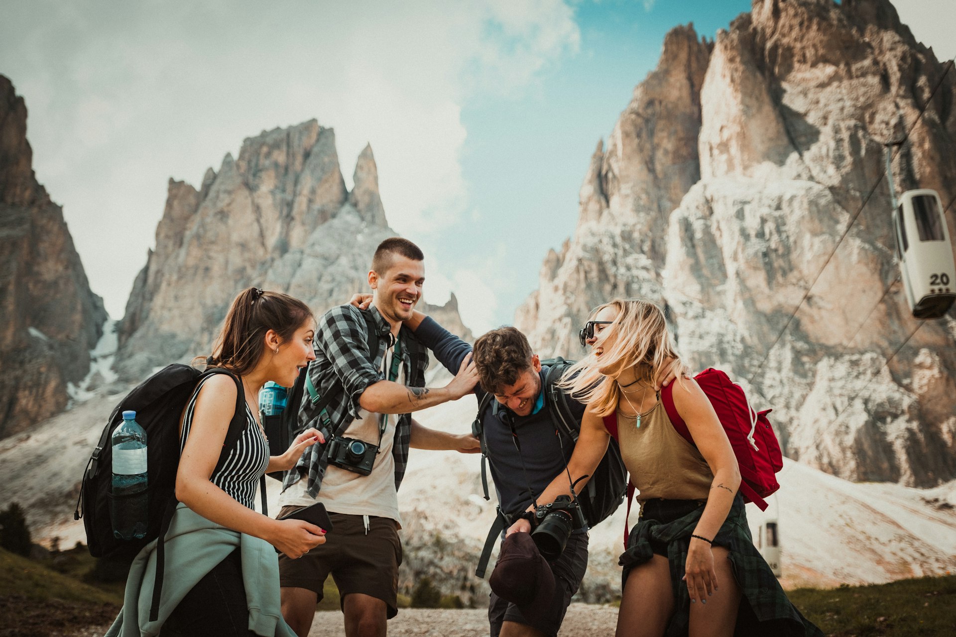 A group of friends laughing together on a mountain trip